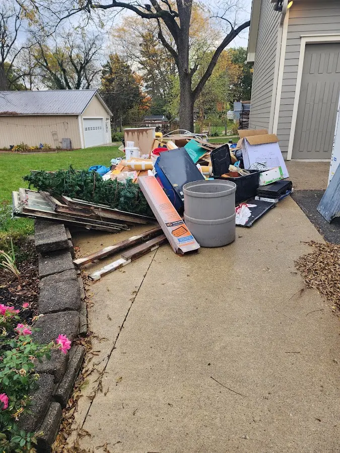 Dumpster being loaded with debris for 12 Yard Dumpster Rental in Montclair